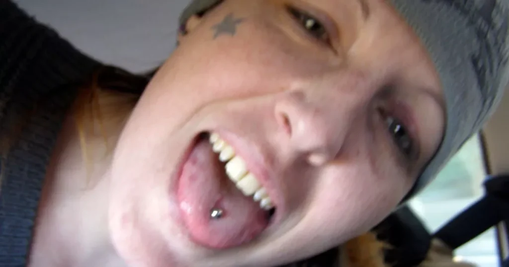 A woman with a piercing in her mouth.